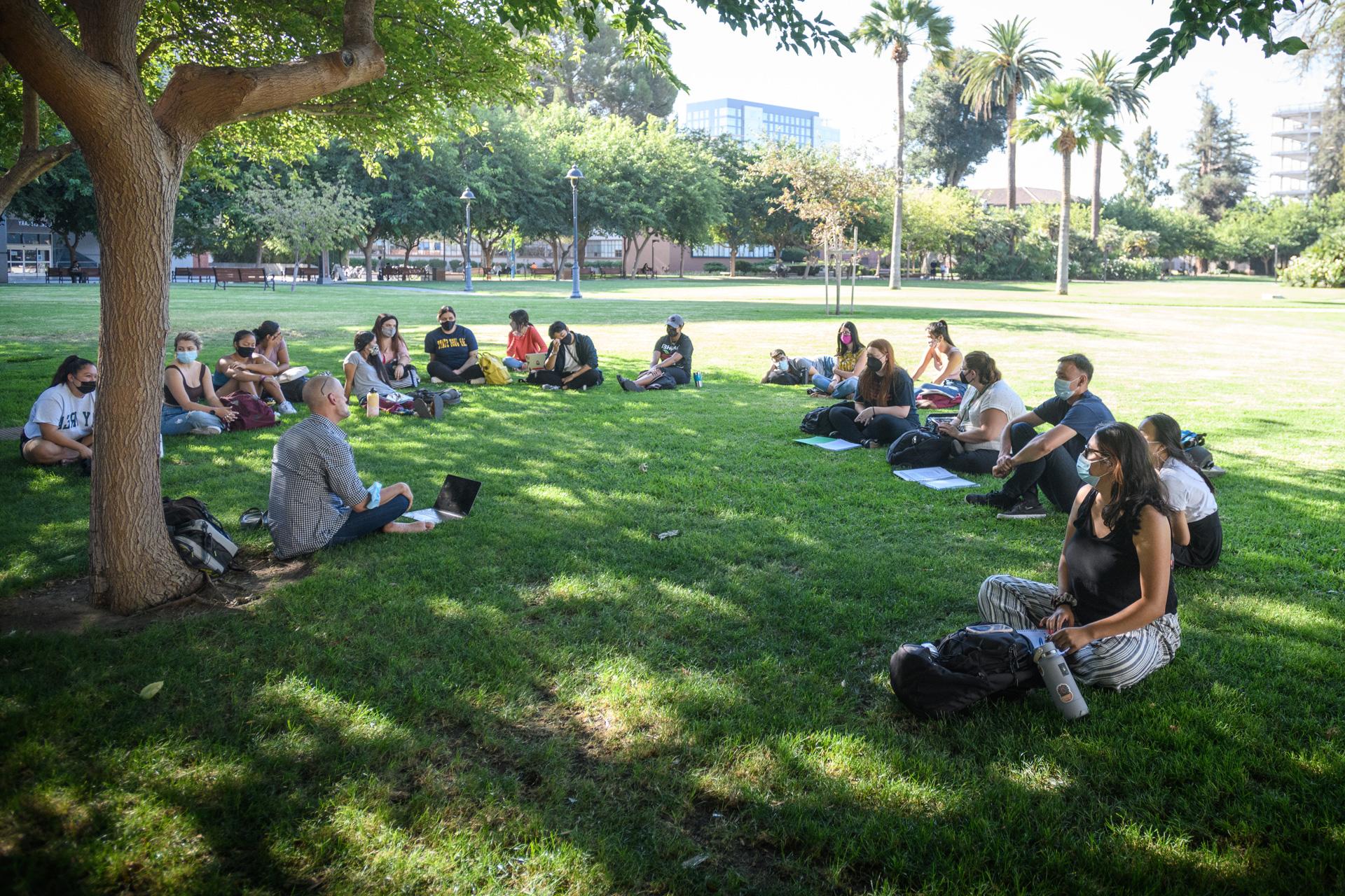 Students gathered together on the grass.
